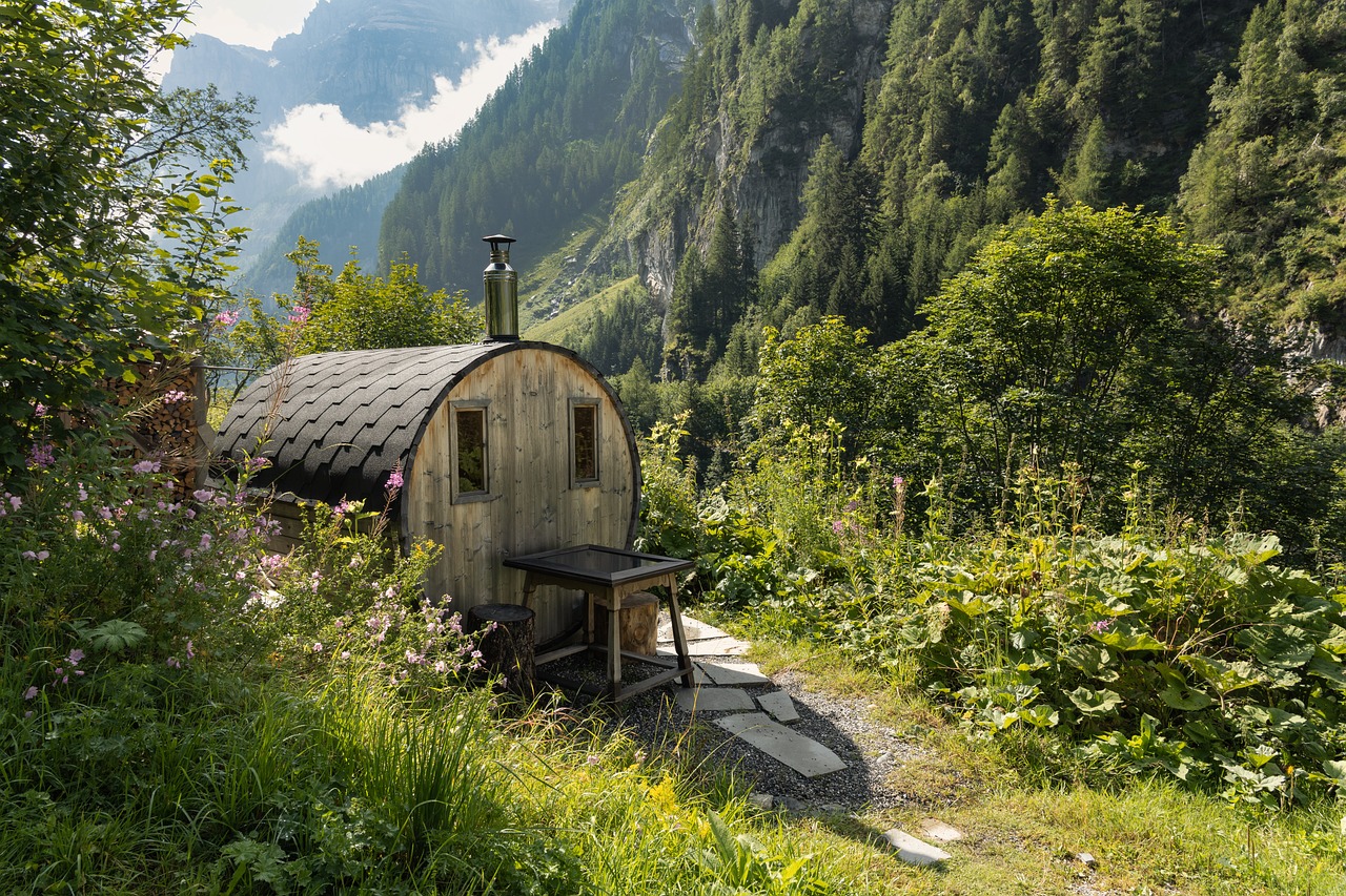 Foto einer kleinen modernen Sauna mitten im Wald in den Bergen.